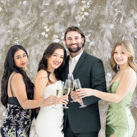 bride and groom with bridesmaids posing in open air photo booth rental wedding