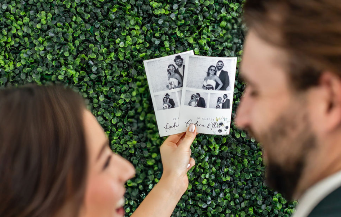 bride and groom looking at photos from wedding photo booth 