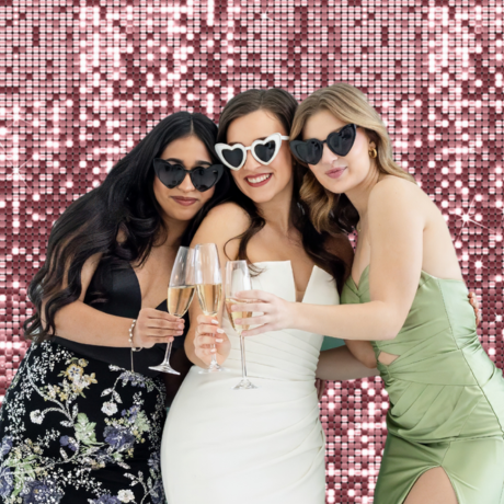 bride and bridesmaids in open air photo booth for wedding reception