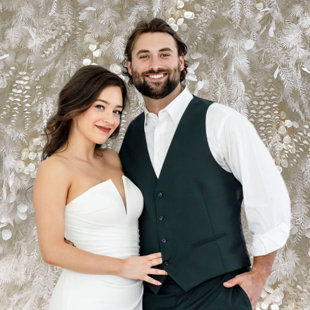 wedding photo booth rental with bride and groom posing in front of cream boho backdrop