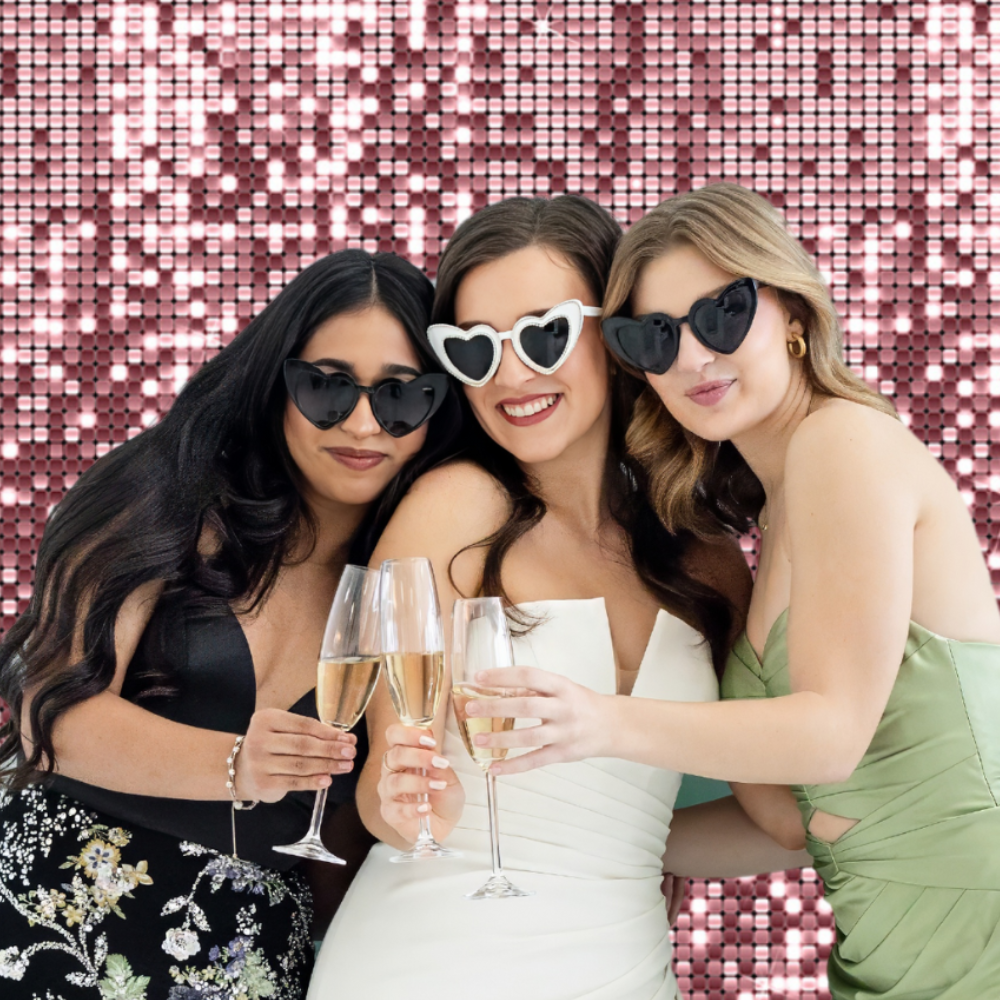 bride and bridemaids in photo booth at wedding reception