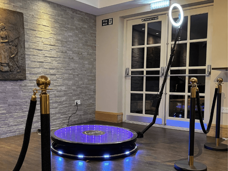360-photo-800x600 Snapqube 360 photo booth rental setup with led glass platform and black stanchions