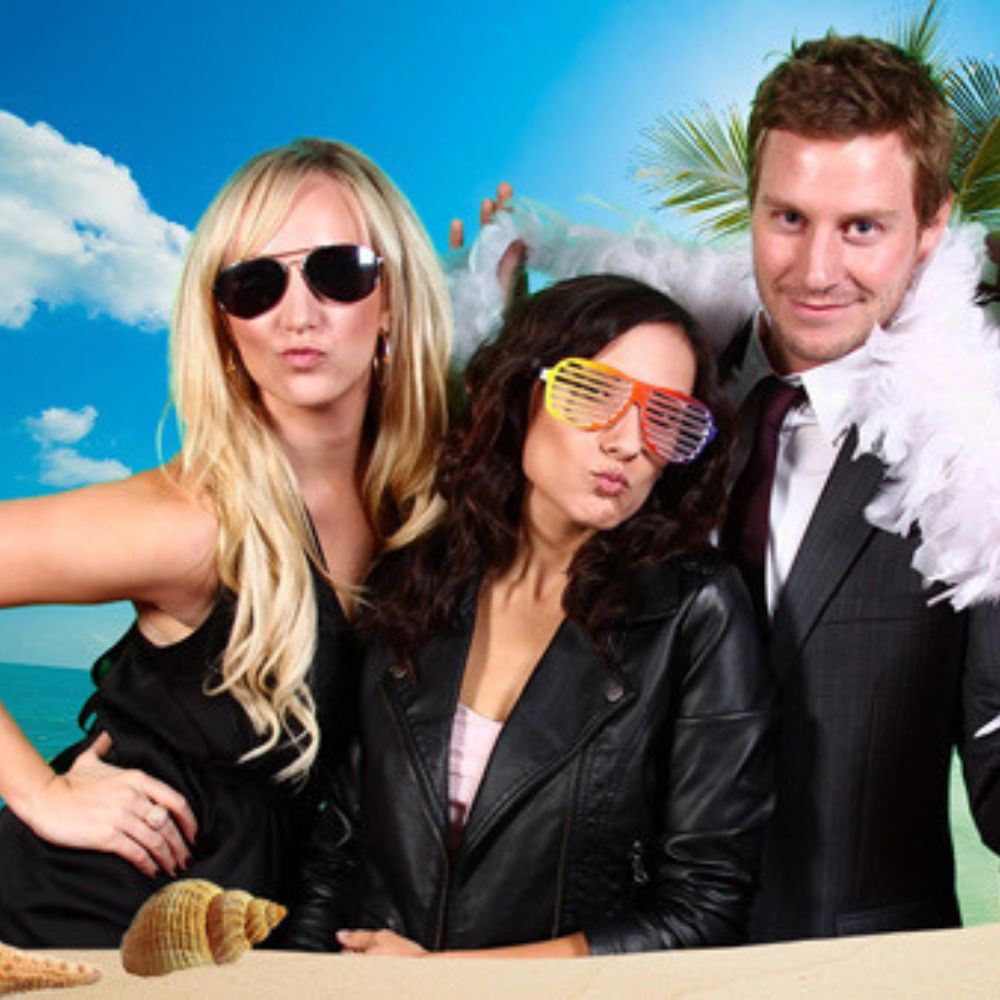 Green-screen-beach(1000 x 1000 px) three employees posing in front of green screen in photo booth rental with beach backdrop